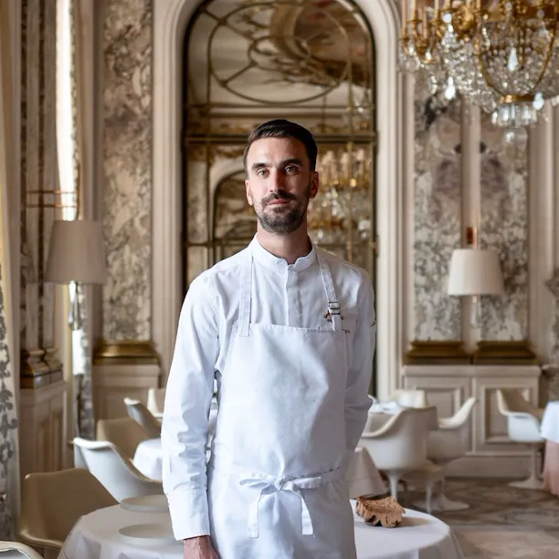 You can observe chef Amaury Bouhours, standing in the middle of Le Meurice Alain Ducasse Restaurant, at Le Meurice, Paris.