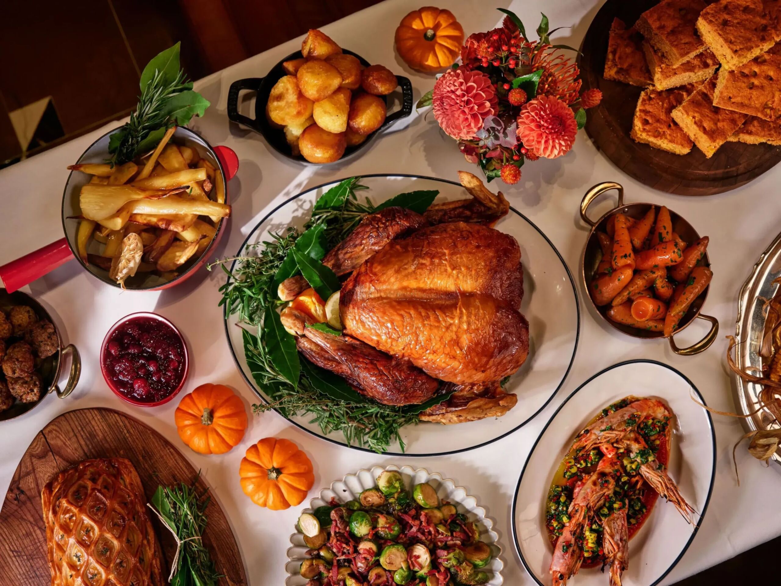 Multiple Thanksgiving dishes on white table cloth at The Grill at The Dorchester