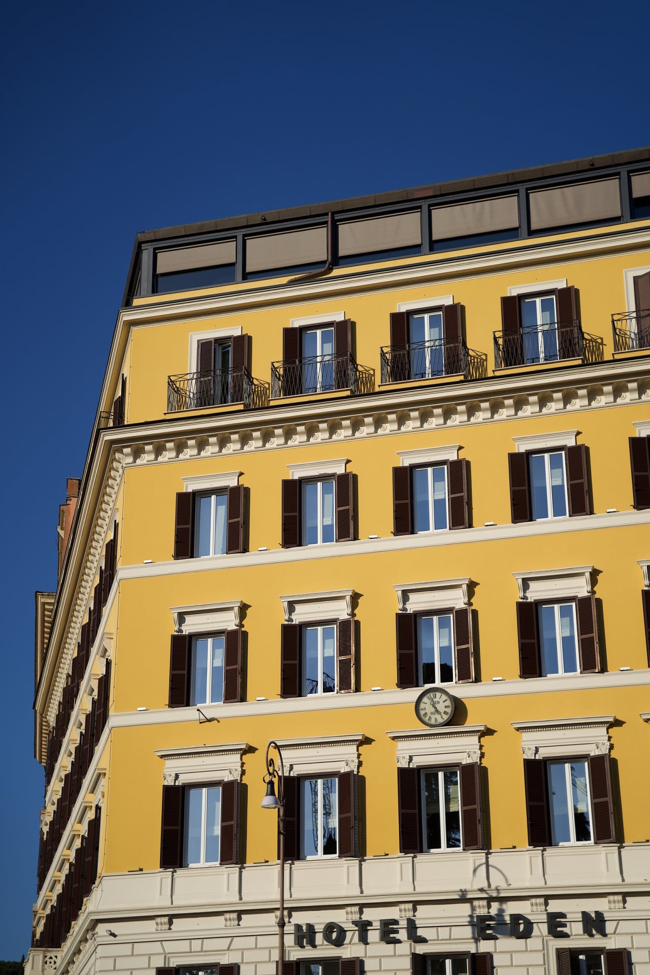 Hotel Eden's yellow exterior building façade, Rome