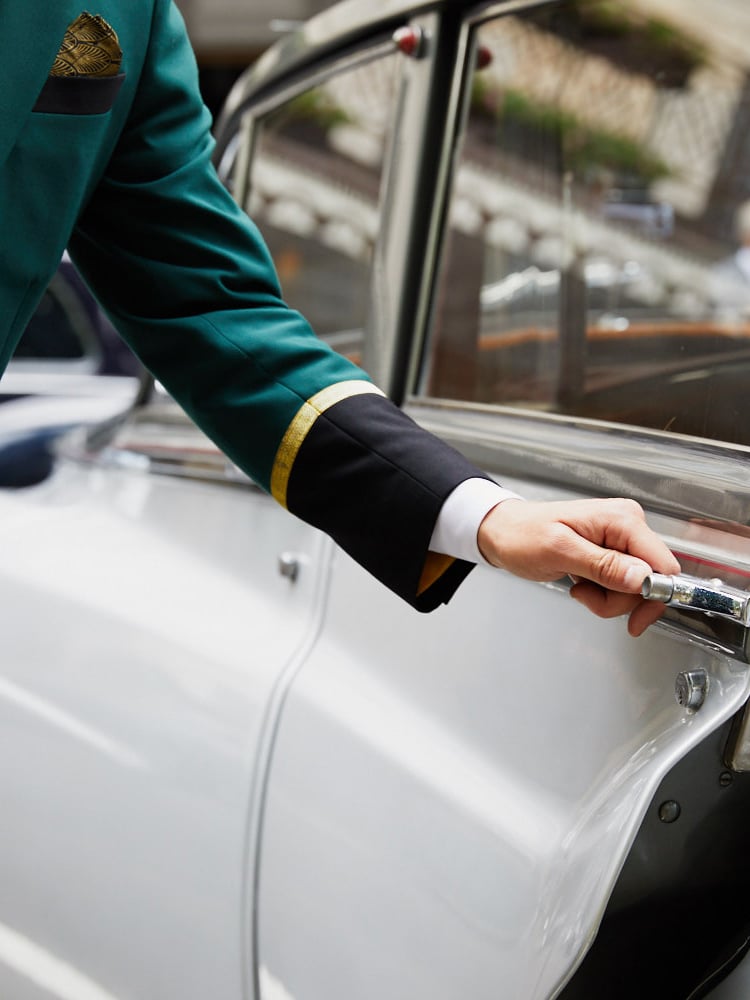 Door man holding the guest's car door handle